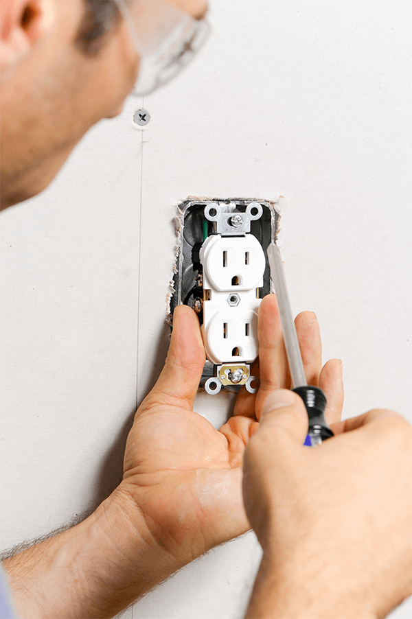 Electrician-Installing-Electrical-Outlet