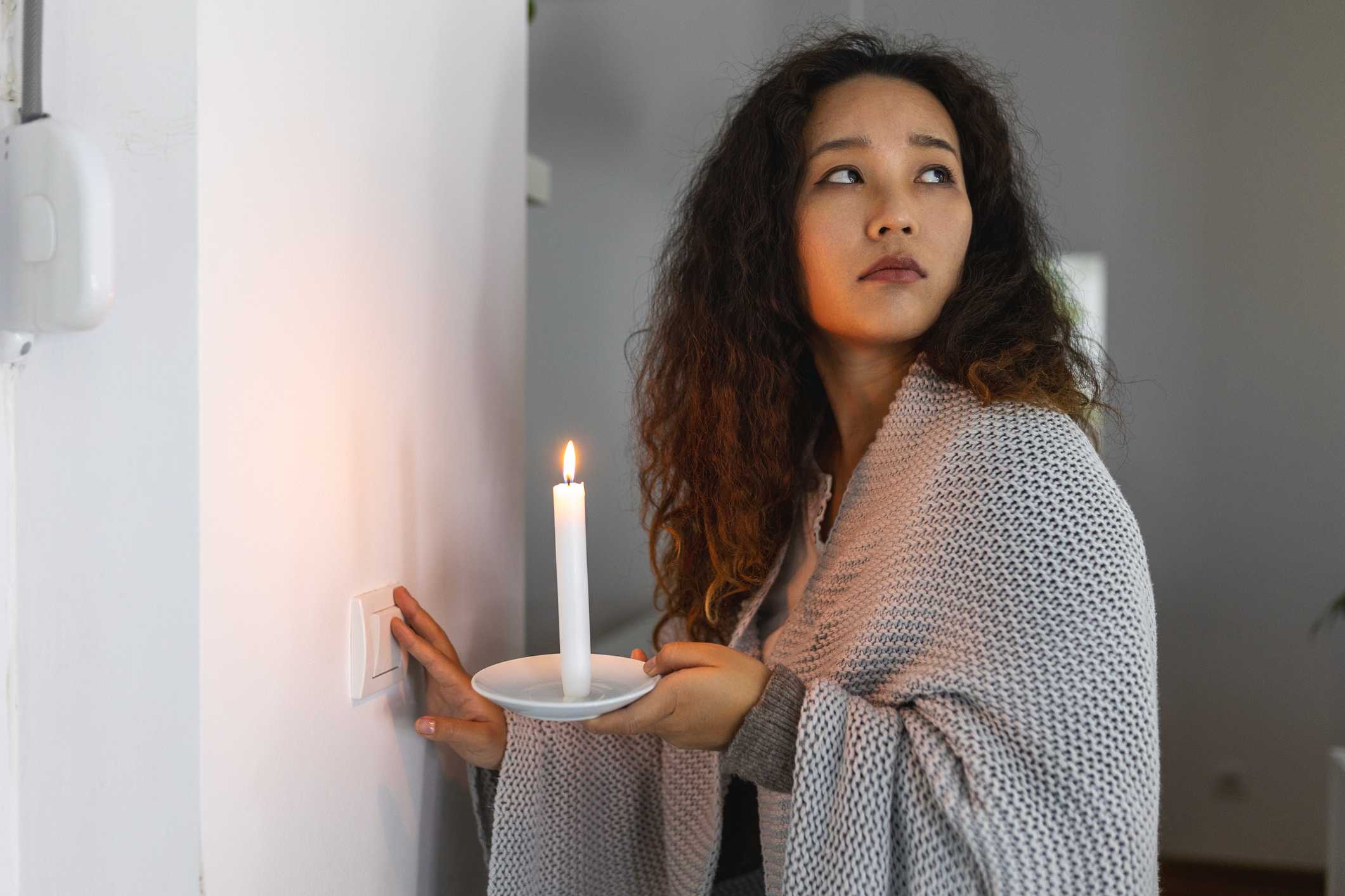 Homeowner holding candle, power outage